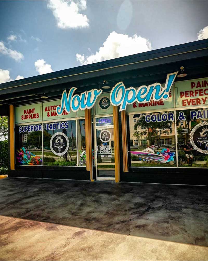 Organized auto paint mixing room with shelves of labeled paint containers inside professional facility, showcasing expert Auto Paint Shop Pompano Beach services for precise color matching and refinishing