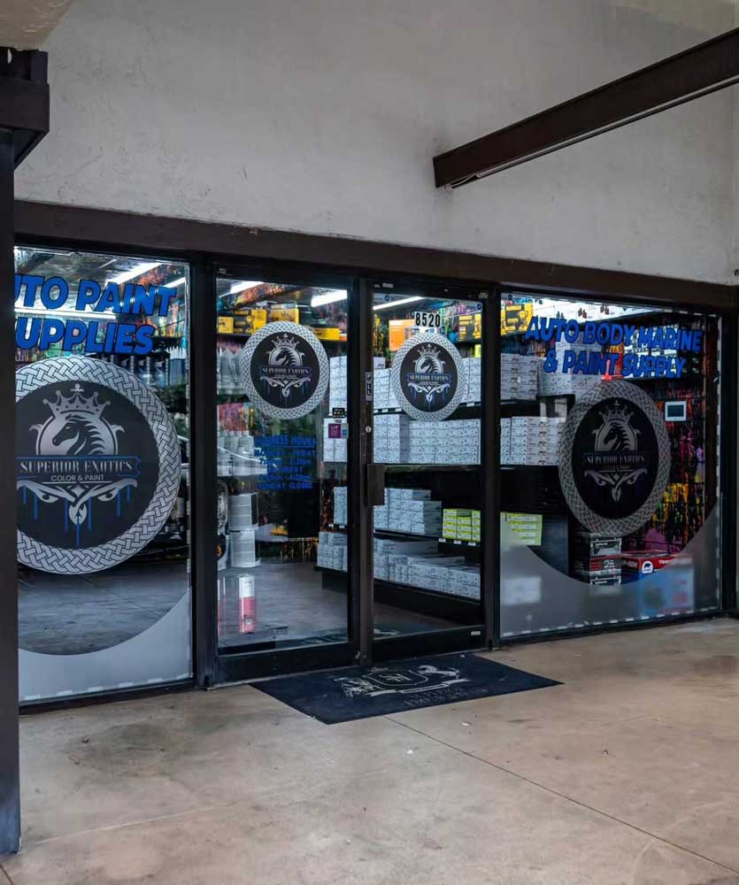 Technicians working on a custom-painted sports car inside a professional auto paint facility, showcasing expert Auto Paint Shop Davie services for precision vehicle paint and detailing
